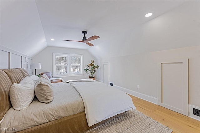 bedroom with hardwood / wood-style floors, ceiling fan, and lofted ceiling