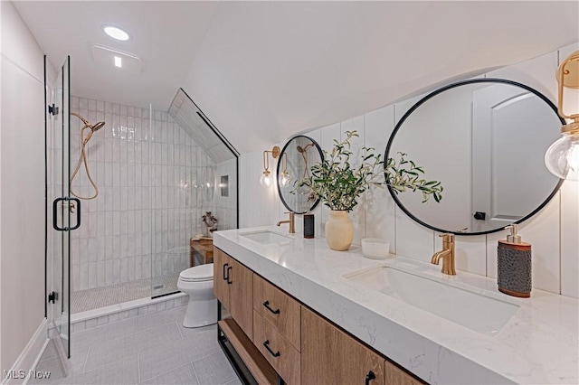 bathroom with vanity, vaulted ceiling, tile patterned flooring, toilet, and an enclosed shower