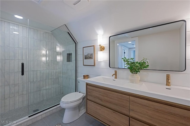 bathroom featuring tile patterned floors, vanity, toilet, and a shower with door