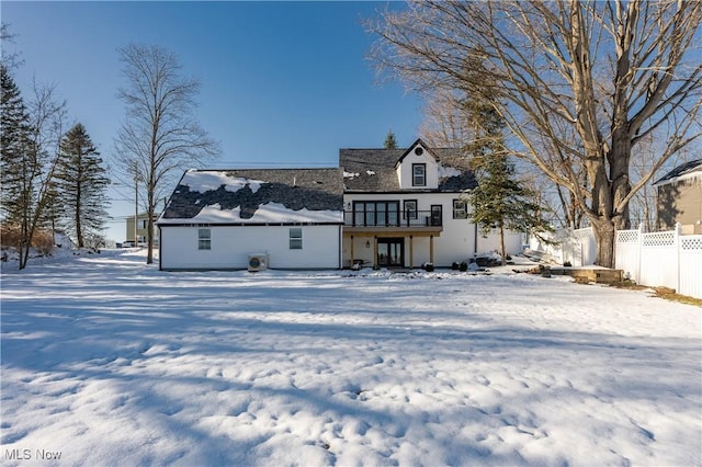 view of snow covered rear of property