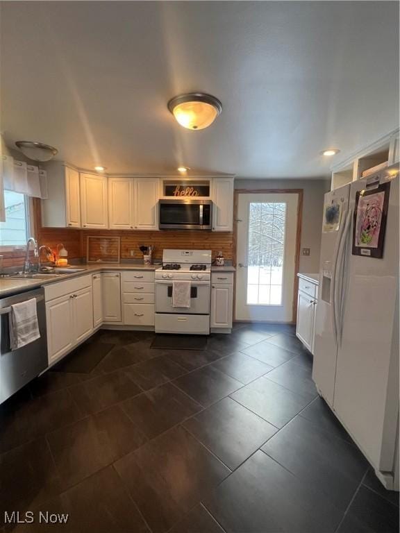 kitchen with white cabinets, sink, and appliances with stainless steel finishes