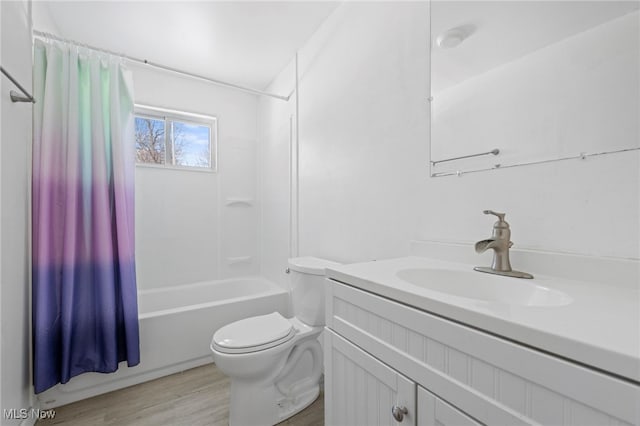 full bathroom with vanity, hardwood / wood-style flooring, shower / bathtub combination with curtain, and toilet