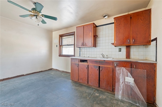 kitchen with backsplash, ceiling fan, and sink