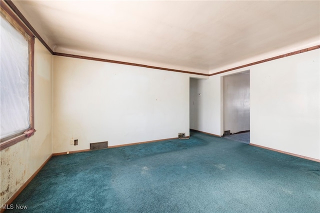 carpeted empty room with crown molding