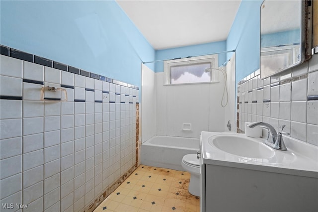 full bathroom featuring vanity, shower / bath combination, toilet, and tile walls