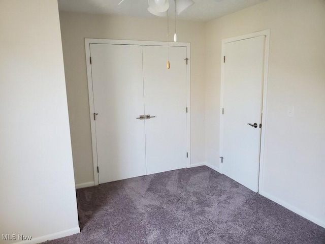 unfurnished bedroom featuring carpet flooring, a closet, and ceiling fan