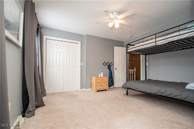 bedroom with visible vents, baseboards, light colored carpet, a closet, and a ceiling fan