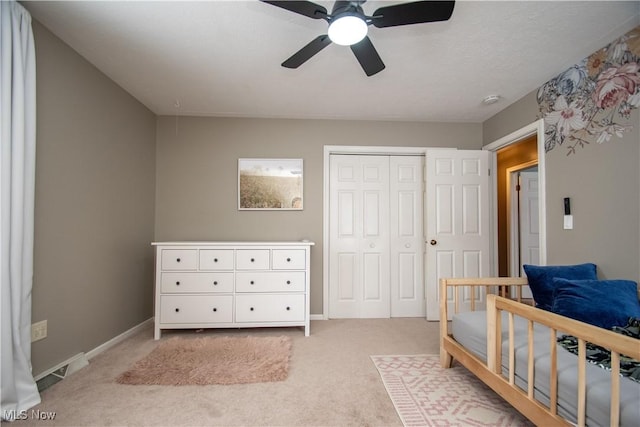 bedroom featuring visible vents, light carpet, a ceiling fan, a closet, and baseboards