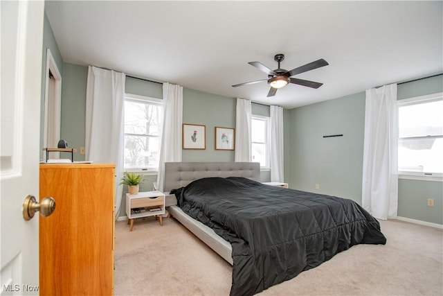 bedroom with baseboards, light carpet, and ceiling fan