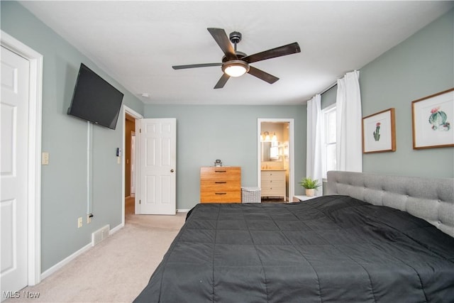 carpeted bedroom featuring visible vents, connected bathroom, baseboards, and ceiling fan