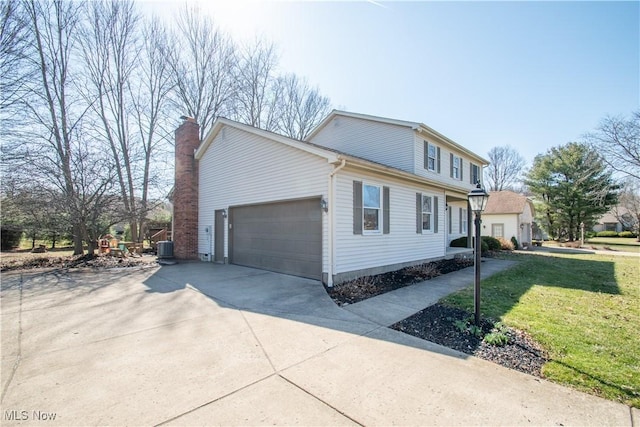 view of side of property featuring central air condition unit, a lawn, a garage, and concrete driveway