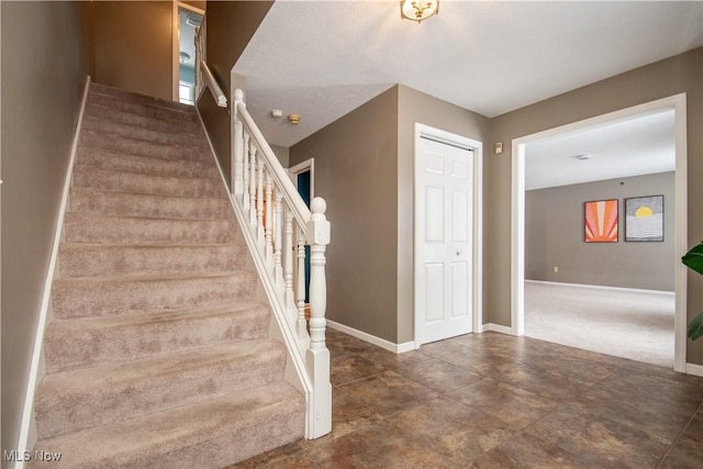 stairway featuring baseboards