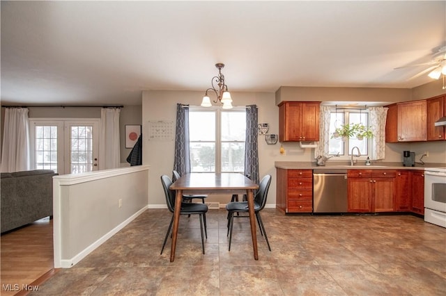 kitchen featuring a wealth of natural light, brown cabinets, and dishwasher