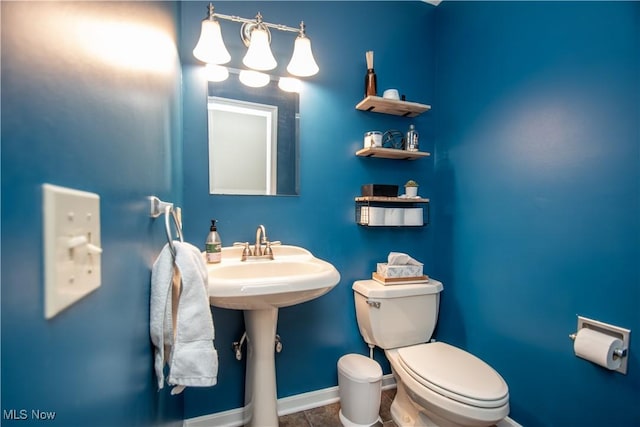 bathroom featuring tile patterned flooring, toilet, and baseboards