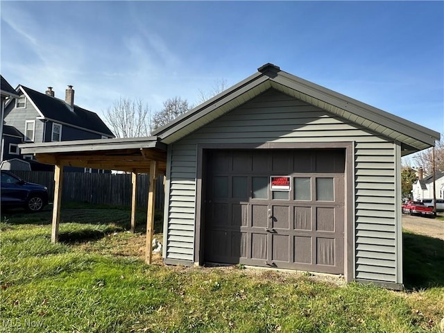 garage featuring a yard and a carport