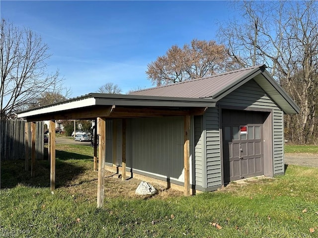 view of property exterior featuring a carport, a garage, an outdoor structure, and a lawn