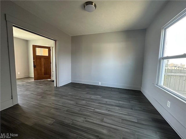 empty room with dark hardwood / wood-style floors