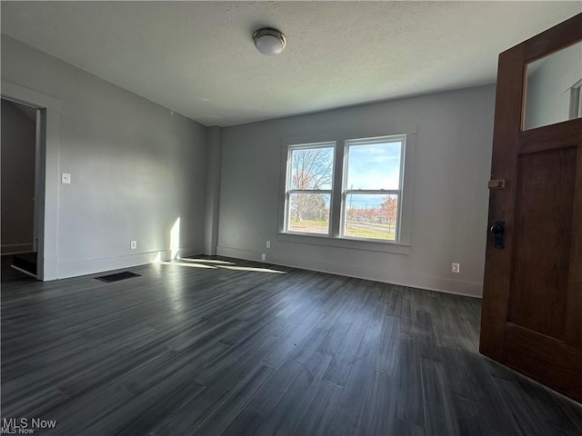 empty room featuring dark hardwood / wood-style floors