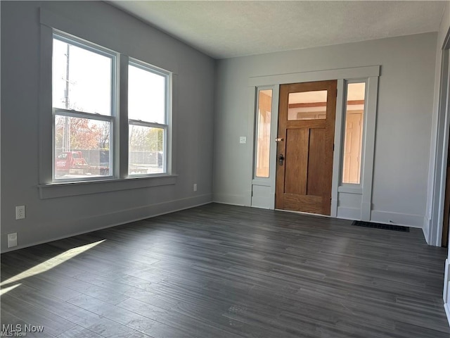 empty room with dark wood-type flooring