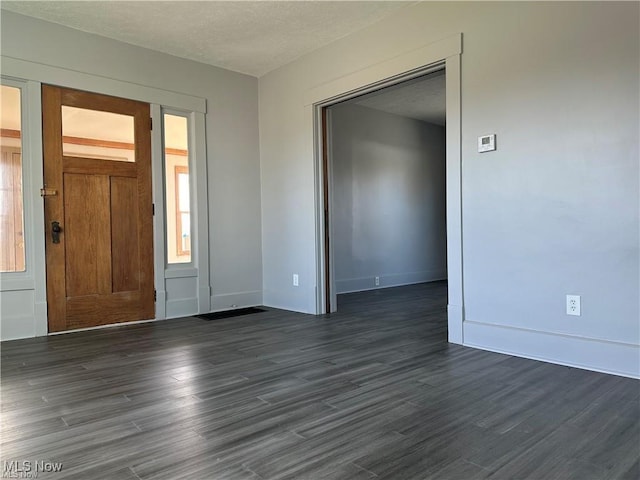 foyer entrance with dark wood-type flooring