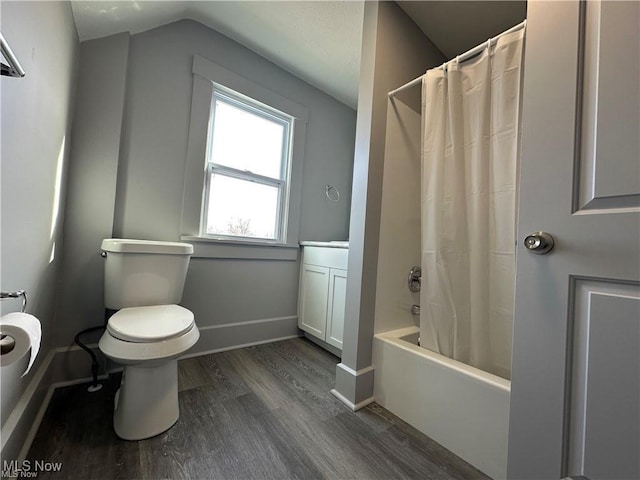 full bathroom with vanity, shower / bath combination with curtain, vaulted ceiling, toilet, and wood-type flooring