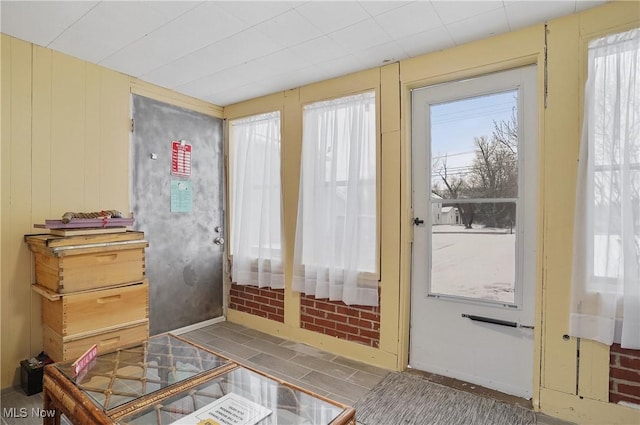 entryway featuring wood walls