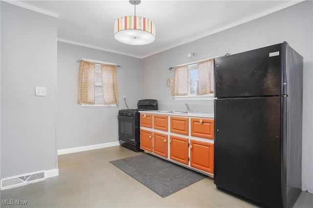 kitchen featuring hanging light fixtures, black appliances, plenty of natural light, and sink