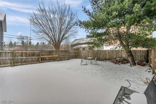 view of yard layered in snow