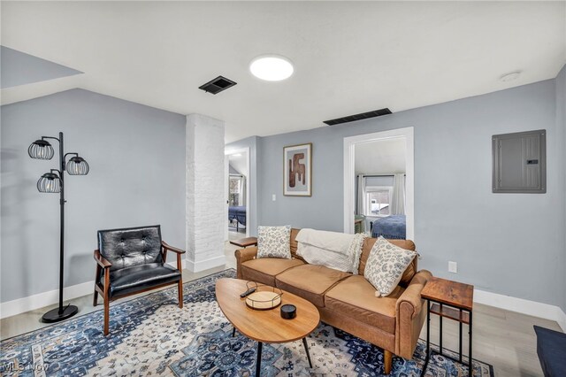 living room featuring light hardwood / wood-style floors and electric panel