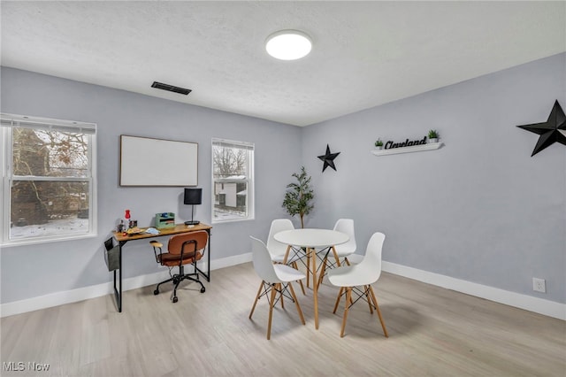 dining space with light wood-type flooring