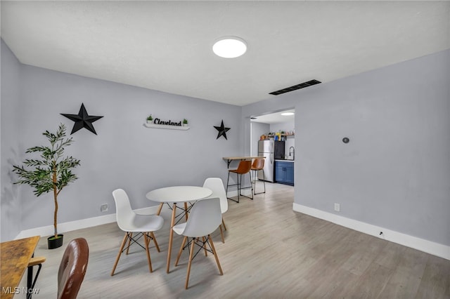 dining area featuring light wood-type flooring