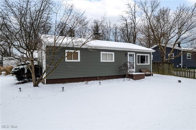 view of snow covered rear of property