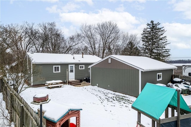 view of snow covered rear of property