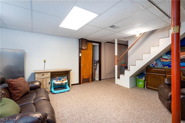 interior space with a drop ceiling and carpet