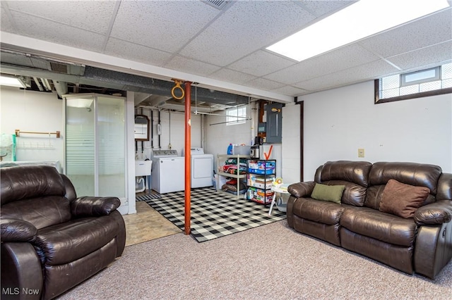 living room with washer and dryer, a paneled ceiling, and carpet