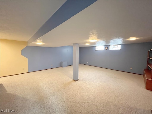 basement with light colored carpet and radiator heating unit