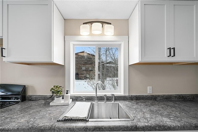 kitchen with white cabinetry and sink