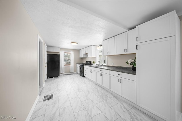 kitchen featuring white cabinets, a textured ceiling, sink, and black appliances