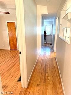 hallway with light hardwood / wood-style flooring