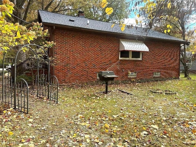 view of side of home with a lawn