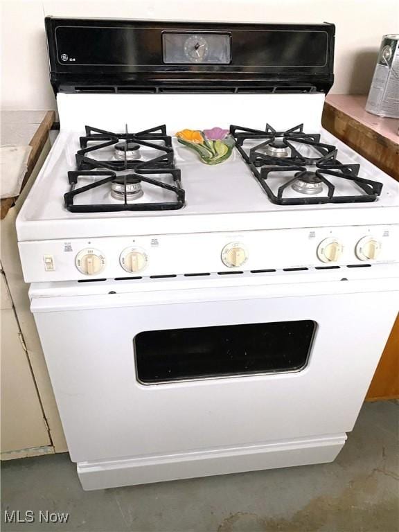 details with white cabinets and white range with gas cooktop