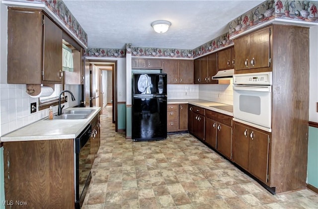 kitchen with decorative backsplash, sink, black appliances, and dark brown cabinets