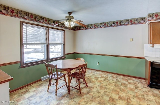 dining room featuring ceiling fan and wine cooler