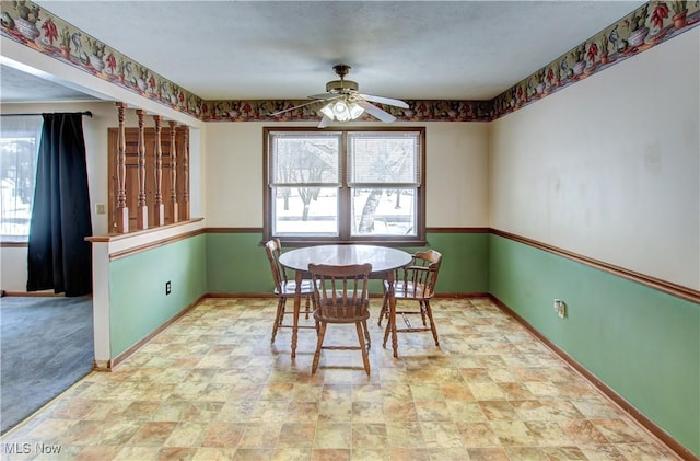 carpeted dining room with ceiling fan