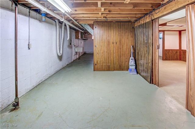 basement with wood walls and sink