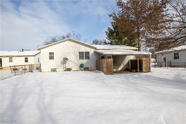 view of snow covered back of property