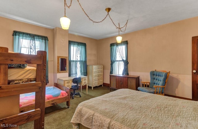 carpeted bedroom featuring multiple windows