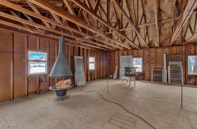 misc room with a wood stove and plenty of natural light