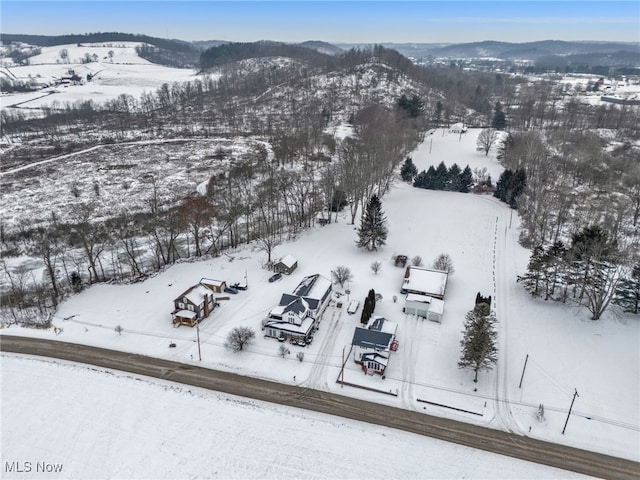 snowy aerial view featuring a mountain view