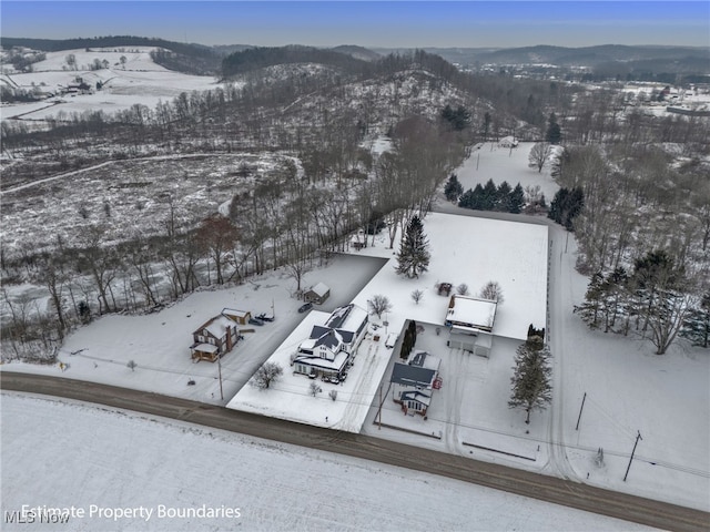 snowy aerial view with a mountain view